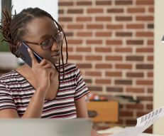 Businesswoman talking to people on smartphone call, using telecommunications phone line to chat with manager and work remotely from home. Chatting on telephone, freelance office job.